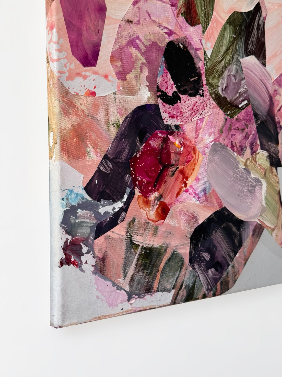 Detail of A Trace of Heart showing textured crimson, lavender and deep plum fragments overlapping pale pink layers near the lower-left canvas corner.