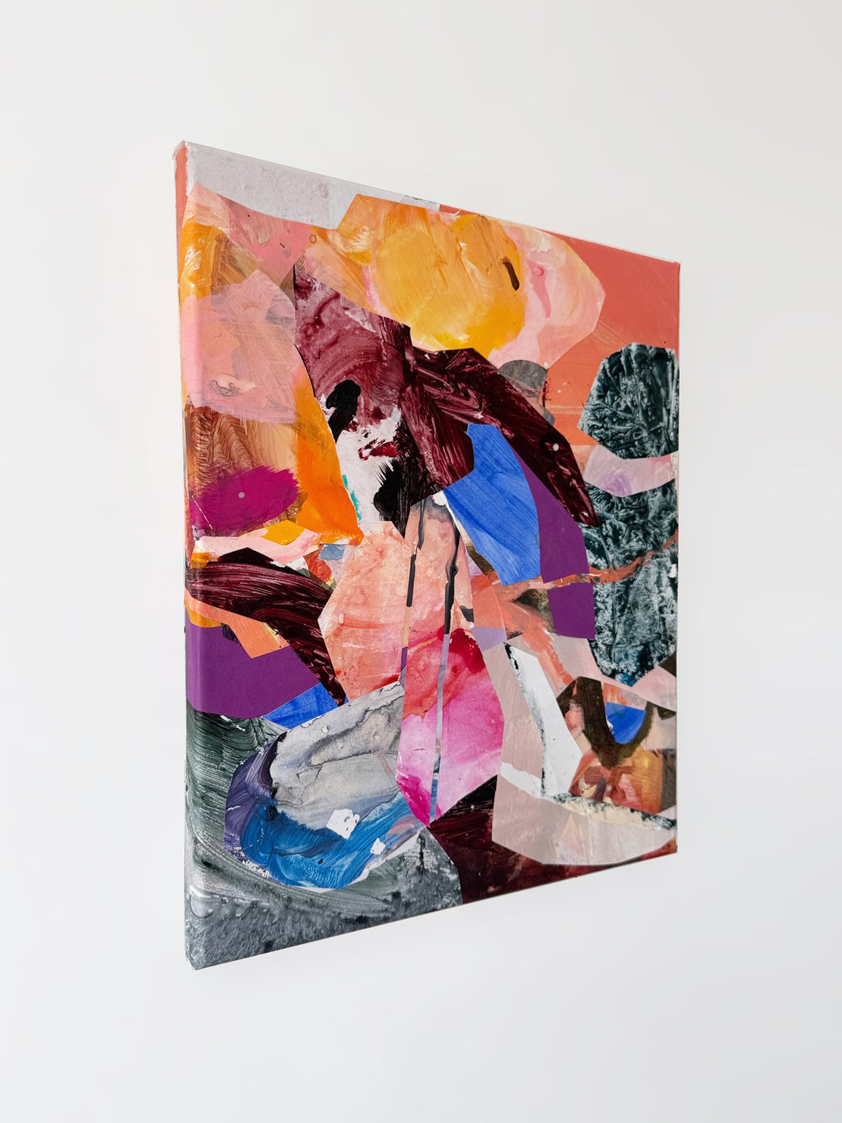 Angled view of Held Together, showing overlapping collage fragments, painted textures and the left edge of the canvas.