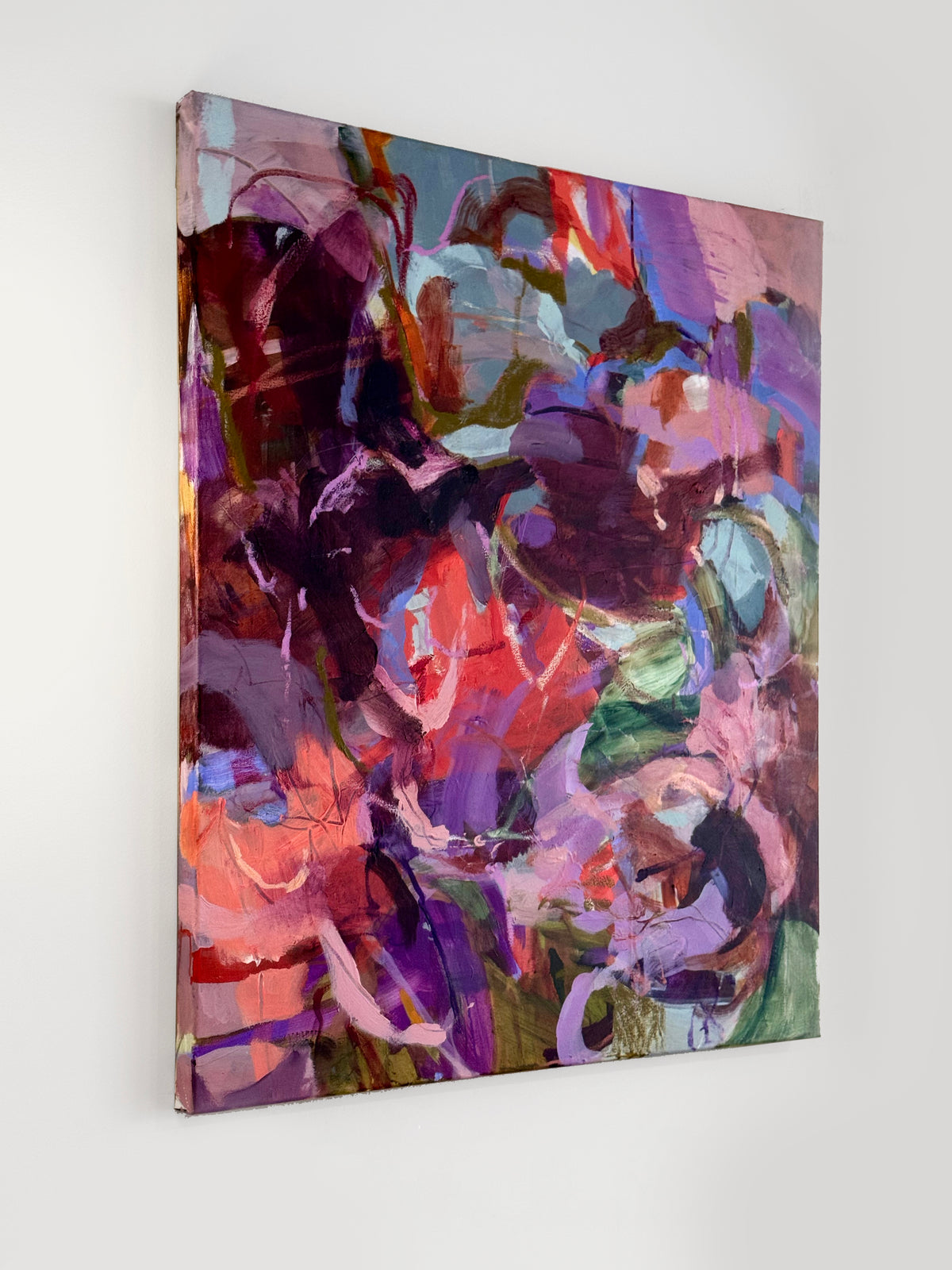 angled view of original painting Her Silence Smelled Like Roses by Anna Rolskaya, an abstract painting in burgundy, pink, plum, lavender and pale blue.
